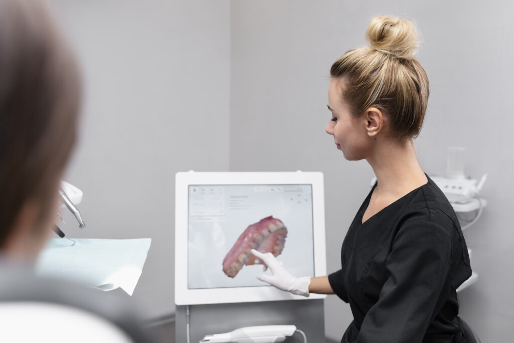 Dental specialist reviewing 3D digital treatment plan with patient showing customized All-on-X implant placement